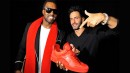 Kanye holding up his red Louis Vuitton's